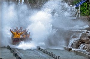 Park officials said a boat on Shoot the Rapids rolled back down the lift hill, while witnesses said the boat capsized with the riders in it.