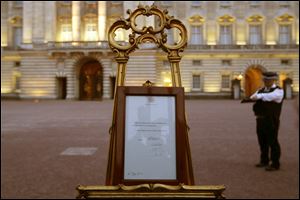 A notice proclaiming the birth of a baby boy of Prince William and Kate, Duchess of Cambridge is display for the public view at Buckingham Palace in London.