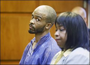 Michael Madison glances at court-appointed attorney Marlene Ridenour. Officials believe he may have been influenced by serial-killer Anthony Sowell.