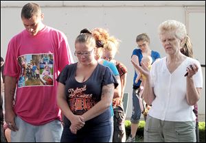 TJ Steinfurth and his girlfriend, Becky Navaugh, pray during the vigil for his missing daughter, Elaina. 