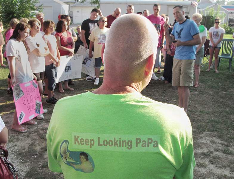 Richard-Schiewe-grandfather-of-Elaina-Steinfurth-listens-to-the-Rev-Steve-Salyers-during-a-vigil-for-Elaina