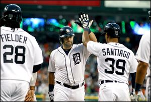 Detroit’s Alex Avila, center, is congratulated after his grand slam by Prince Fielder, left, and Ramon Santiago in the sixth inning.