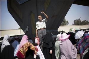 A supporter of Egypt's ousted President Mohammed Morsi raises his fist during a women's march against Egyptian Defense Minister Gen. Abdel-Fattah el-Sissi in Nasr City, Cairo, Egypt, Tuesday, July 30, 2013. 