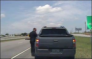 In this image taken from dashcam video provided by the City of Forney, Texas police department, a police officer speaks with George Zimmerman. 