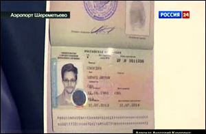 Russian lawyer Anatoly Kucherena shows Edward Snowden's a temporary document Russia while speaking to the media after visiting the National Security Agency leaker at Sheremetyevo airport outside Moscow Thursday.