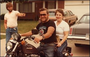 A 1984 photo shows Martin Fewlas on a motorcycle with his wife, Donna Fewlas. Pointing to the couple is Mr. Fewlas' nephew, James McLaughlin.