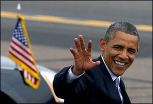 President Barack Obama waves to the crowd as he arrives at Phoenix Sky Harbor International Airport in Phoenix, Tuesday, Aug. 6, 2013, on his way to give a speech on housing and the middle class.