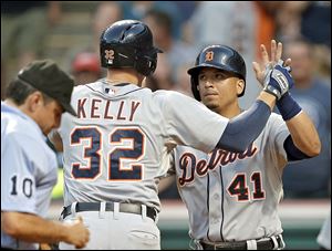 Detroit's Don Kelly is greeted by Victor Martinez after Kelly's three-run home run in the fifth inning Tuesday night against Cleveland.