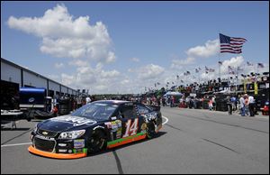 Tony Stewart drives in the garage area.