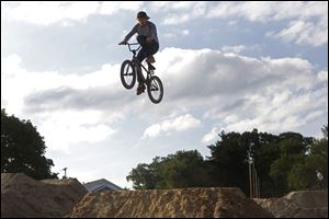 Chris Prebula, 18, of Petersburg, Mich., hits a jump at the Jermain bike park in West Toledo. Prebula has been on a bike since he was three years old, though he just began jumping BMX bikes two years ago. 