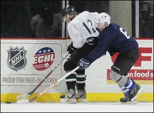 Matt Trautlein, right, of Waterville, battles Shane Shiring of Pittsburgh at the Walleye's free-agent camp. Trautlein played at Anthony Wayne High School.