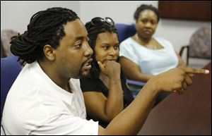 Cyrus Jones II  speaks during a Blade forum on what blacks should  do when stopped by police as his wife, Teanna Jones, center, and Leslie Gray listen. He says he doesn’t know if white parents give their sons ‘the talk.’ 