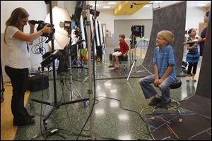 Mark Curtis, 10, flashes a joking grin as he poses for a school picture during orientation.