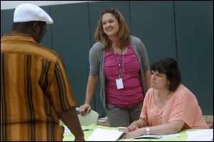 Principal Angela Schaal, center, works with staff members, parents and students during orientation.