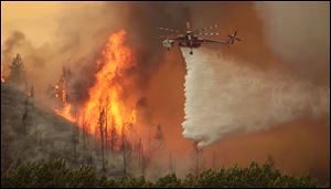 Helicopters battle the 64,000-acre Beaver Creek Fire on Friday north of Hailey, Idaho.