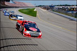 Driver James Buescher (31) enters turn one during the NASCAR Camping World Truck Series Michigan National Guard 200 at Michigan International Speedway.