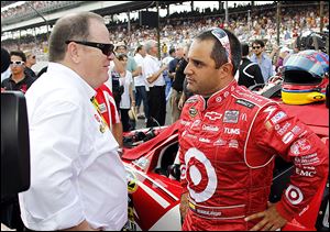 Juan Pablo Montoya, right, talks with soon to be former team owner Chip Ganassi. The driver may drive for Michael Andretti’s Andretti Autosport team next season pending getting sponsorship.