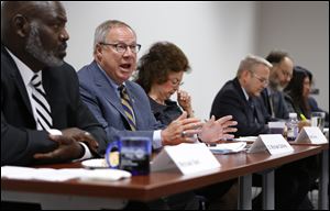 D. Michael Collins, second from left, said conflict earlier this year and last year between council and Mayor Bell regarding federal funding for homeless shelters was unacceptable.