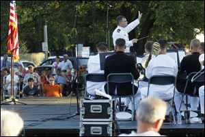 Navy Lt. Patrick Sweeten, center, leads a joint concert between the Navy Band Great Lakes Wind Ensemble and Marine Corps Band New Orleans held at Commodore Square last August.