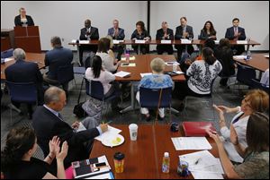 Moderator Holly Ball, public policy lead for the United Way, introduces the candidates during a mayoral candidate forum at The United Way of Greater Toledo. The candidates are from left, Mayor Mike Bell, D. Michael Collins, Opal Covey, Alan Cox, Michael Konwinski, Anita Lopez and Joe McNamara. 