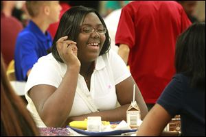 Sophomore Yazmine Reynolds laughs with Lailanai Tompkins at lunch on their first day of school at Waite High School.