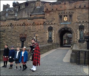 Kids in local garb are 'piped in’ before an after-hours tour of Edinburgh Castle.