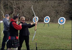 An archery lesson on the grounds of Glamis Castle is among the activities on the Adventures by Disney tour of Scotland.