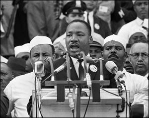 Dr. Martin Luther King Jr., head of the Southern Christian Leadership Conference, addresses marchers during his 