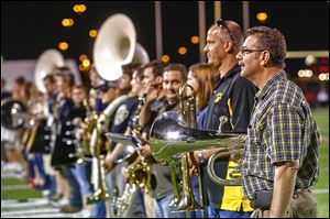 Bob Jender, Matt’s father, stands at the end of the line of alumni band members during Friday’s halftime performance.