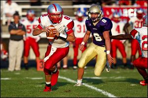 Bowsher senior quarterback Mac Jewell looks to pass as Maumee's Jordan Spellis closes in. Jewell threw for 783 yards last season.