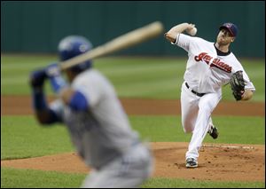 Cleveland Indians starting pitcher Zach McAllister, right, delivers to Kansas City Royals' Emilio Bonifacio, left, in the first inning.