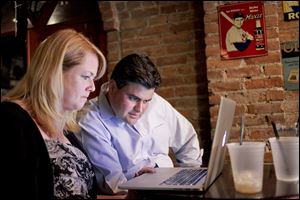 Democratic mayoral candidate Joe McNamara, watches the results come in along with his wife, Valerie Moffitt, during his election-night party at The Attic. 