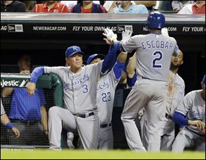 Kansas City Royals manager Ned Yost (3) congratulates Alcides Escobar (2) after Escobar hit a solo home run off Cleveland Indians starting pitcher Zach McAllister in the fifth inning