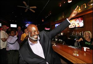 With supporters, Mayor Mike Bell celebrates his first-place showing.