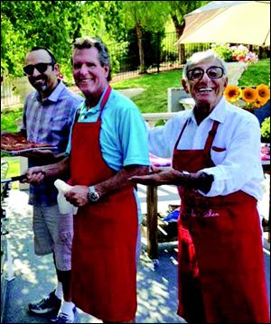 Jonas Farr, left, and Jeff Kendell, center, celebrate Jamie Farr’s birthday at his home in California.