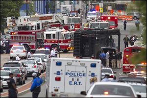 A Emergency Response Team vehicle arrives to the scene where a gunman was reported at the Washington Navy Yard in Washington, on Monday, Sept. 16, 2013. At least one gunman launched an attack inside the Washington Navy Yard, spraying gunfire on office workers in the cafeteria and in the hallways at the heavily secured military installation in the heart of the nation's capital, authorities said.  (AP Photo/Jacquelyn Martin)