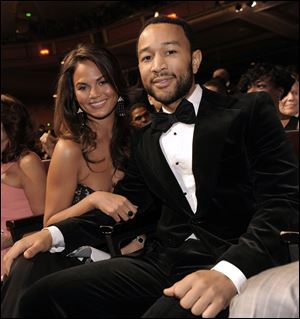 John Legend, right, and Christine Teigen.