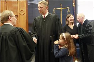 Judge Frederick McDonald, left, congratulates Judge Michael R. Goulding after his Investiture Ceremony at the Lucas County Courthouse.