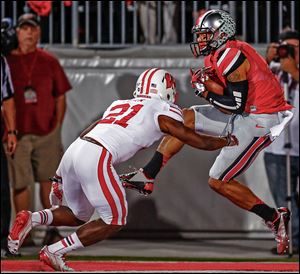 Ohio State wide receiver Devin Smith makes a catch for a touchdown against  Wisconsin cornerback Peniel Jean in the first quarter. The Buckeyes built a 24-14 lead by halftime to improve to 5-0.