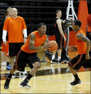 Anthony Henderson looks to go past Damarkeo Lyshe as Bowling Green began basketrball practice on Monday.