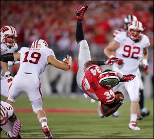 Ohio State tailback Carlos Hyde goes flying past Wisconsin's Leo Musso in Saturday's game. Hyde had 85 yards on 17 carries. The No. 4 Buckeyes play Saturday at No. 16 Northwestern.