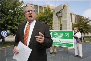 Toledo mayoral candidate D. Michael Collins criticizes Mayor Mike Bell for slashing homeless shelter budgets the past two years during a news conference Monday. 'Under my administration, there will be a complete change,' Mr. Collins said.