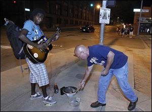 Earl Cookie performs outside of Fifth Third Field during a game.