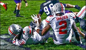 Ohio State’s Bradley Roby, left, recovers a blocked punt next to Ryan Shazier against Northwestern in the end zone for a touchdown Saturday night in the first half.