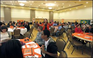 Laura Saavedra, center, admission representative at Bowling Green State University, encourages Latino high school students to consider attending Bowling Green State University.