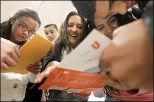 Students from Western International High School in Detroit, from left, Vanessa Varela, 16, David de Luna, 16, Carolina Guiterrez, 16, Analisa Alvarez, 16, and Juan Flores, 16, look over a map of the campus at Bowling Green State University for a scavenger hunt during an event called ‘El Encuentro,’ or ‘The Encounter.’ The program is designed to attract Latino high school students to the university.