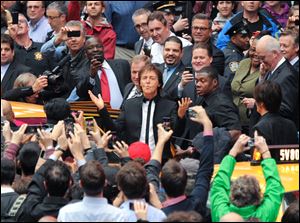 Paul McCartney arrives with his band to give a surprise pop up concert in Times Square. McCartney will release his new album called ‘New’ on Tuesday.