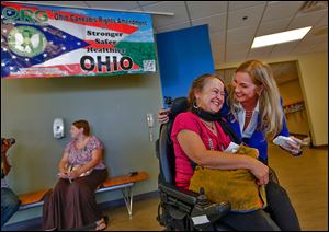 Tanya Davis of Kettering catches up with friend and fellow medical marijuana activist Cheryl Shuman before a panel discussion at the University of Toledo. Events today include an expo at Headliners.