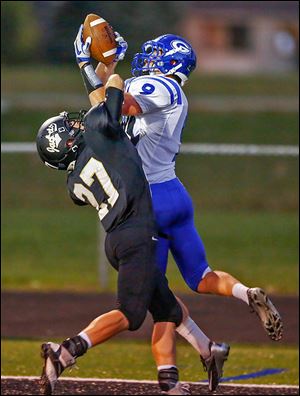 Anthony Wayne's Eric Zelina hauls in a 16-yard TD pass over Perrysburg's Zach Honsberger during the first quarter on Friday.