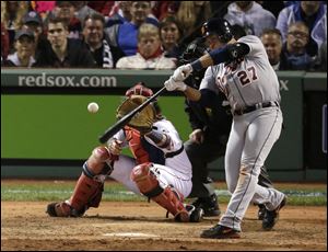 Detroit's Jhonny Peralta hits a double in front of Red Sox catcher David Ross during the eighth inning of Game 1 in theAL championship series Saturday in Boston.